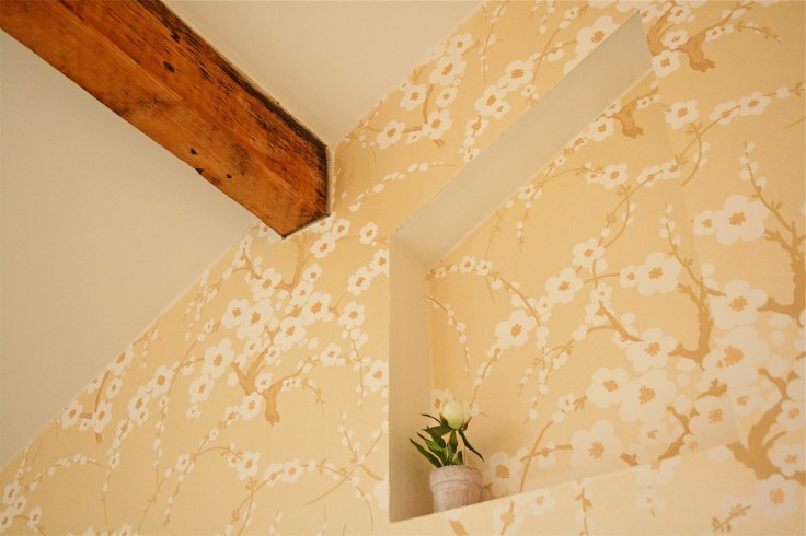 Recessed shelf in stud wall with Laura Ashley Lori paper and exposed beam