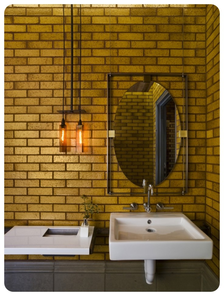 Gold metro or subway tiling on full bathroom wall
