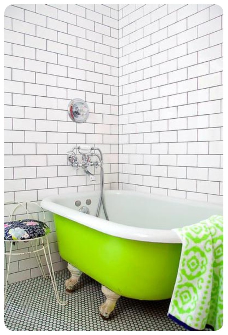 Lime green slipper bath in white metro tiled bathroom