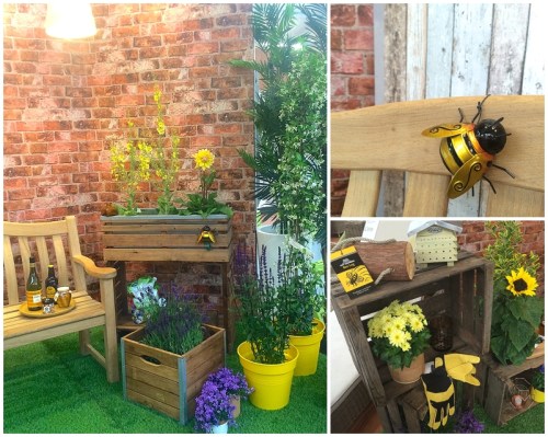 Natural timbers and wooden planters in bee friendly garden space with reclaimed brick backdrop